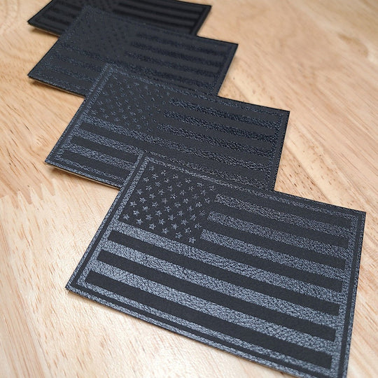 Single Track Hats black leatherette patch with embossed USA flag design. Subtle patriotic accessory.