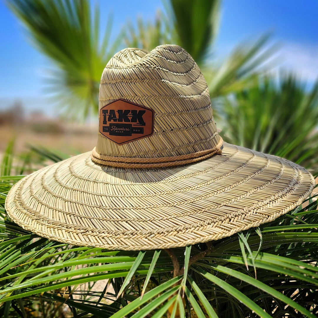Single Track Hats natural straw sun hat with custom leatherette patch and rope trim. Perfect for beach and sun protection.