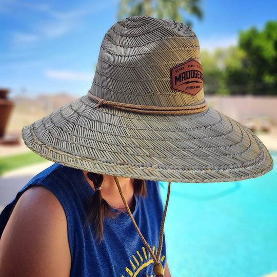 Single Track Hats natural straw sun hat with wide brim and custom leatherette patch. Features a rope strap.