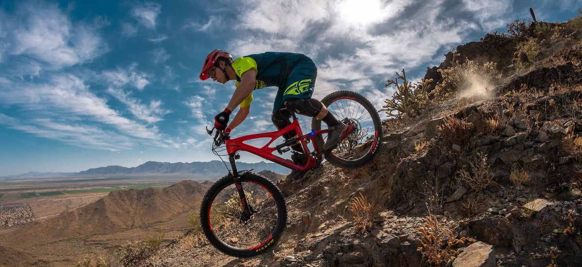 Ryan riding a mountain bike down a rocky desert trail near Phoenix