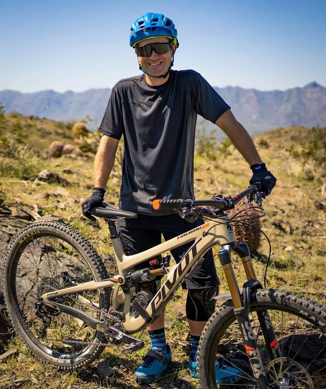 Ryan, co-founder of Single Track Hats, with his mountain bike in the Arizona desert