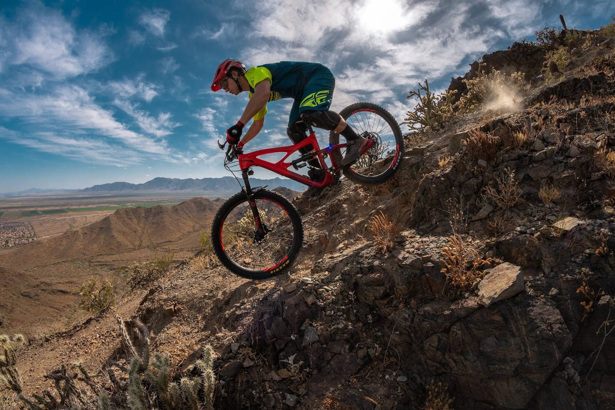 Ryan riding a mountain bike down a rocky desert trail near Phoenix
